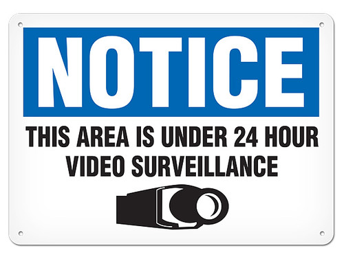 A photograph of a 01661 notice this property is under 24 hour video surveillance OSHA sign with video camera icon.