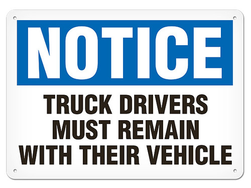 A photograph of a 01644 notice truck drivers must remain with their vehicle OSHA sign.
