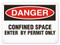 A photograph of a 01709 danger, confined space enter by permit only OSHA sign.