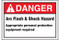 A photograph of a red and white 07330 ANSI danger arc flash label, with basic text.