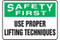 A photograph of a green and white 12309 safety first, use proper lifting techniques sign.