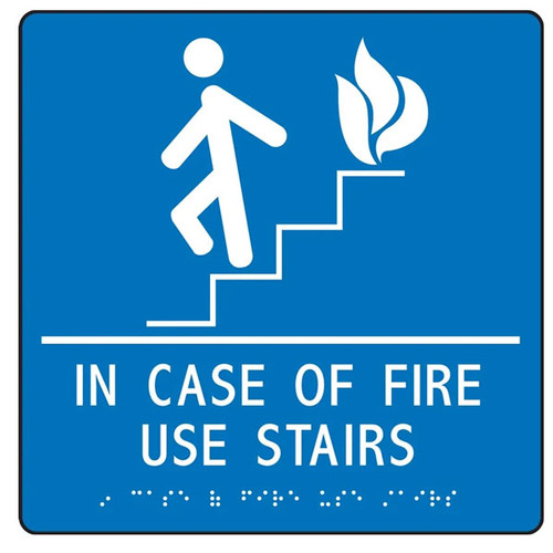 A photograph of a white on blue 03503 ADA braille tactile sign, reading in case of fire use stairs with person on stairs icon.