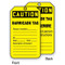 A photograph of front and back of a yellow 12274 caution barricade tag.
