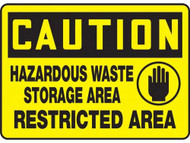 A photograph of a yellow and black 01552 caution hazardous waste storage area Restricted Area OSHA sign.