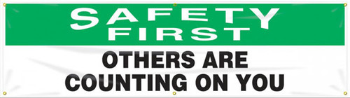 Picture of Workplace Safety Banner that features a professional white background with green header, and wording "Safety First" in bold white text in the header. Below is the wording "Others Are Counting On You" in serious black text.	