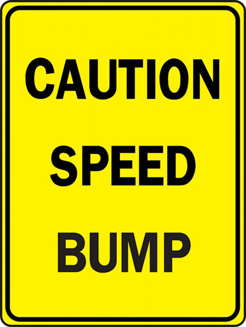 A photograph of a yellow and black 06251 speed bump sign, reading caution speed bump.