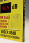A close-up photograph showing decimal meter and earplug dispenser of sign.