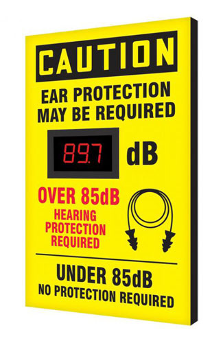 A photograph of a yellow and black 11106 OSHA caution industrial decibel meter sign, reading ear protection may be required - over 85 db hearing protection required, with dimensions 20" x 12".