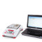 Photograph of Ohaus Adventurer® Precision Balance without draft shield, left facing connected to laptop (not included).
