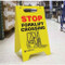 A photograph custom yellow A-Frame Standing Floor sign, standing upright. The front face has STOP in red with FORKLIFT CROSSING below that in black, a forklift drawing, and the company name.