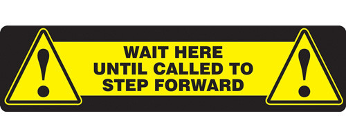 A photograph of a yellow and black 11202 social distance floor sign, reading wait here until called to step forward, with dimensions 6" x 24", and alert icons.