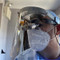 Person wearing the face shield with dental loupes and N95 facemask; partial head-on view.