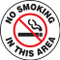 A photograph of a black and white 11258 pavement print sign, reading no smoking in this area, with a no smoking graphic.