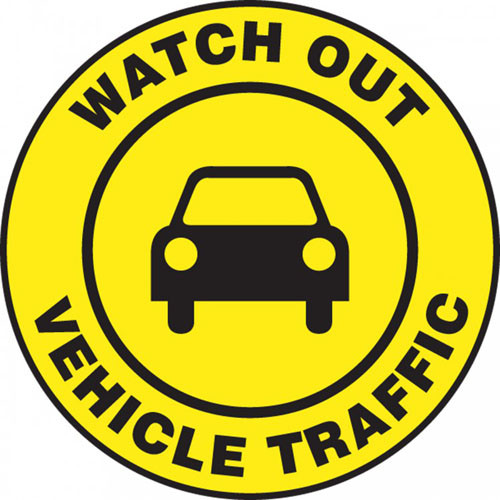 This black and yellow sign reads "Watch Out Vehicle Traffic" in a yellow strip along the border. The center features a black image of a car on a yellow background. Use in areas that see frequent vehicle traffic and usage.