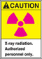 This sign has an ANSI CAUTION header on a yellow background, a magenta international radiation symbol, and a white text box with "X-ray radiation. Authorized personnel only." in black text.