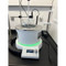 A photograph of a Scilogex LCD Digital Magnetic Stirring Bath in use.  A large beaker is being heated in the bath.