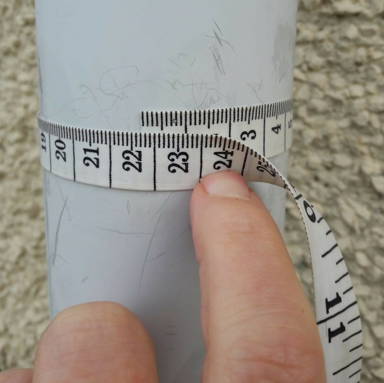 Measuring a downpipe with a dressmakers tape