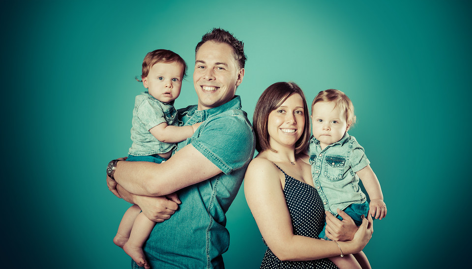 Beautiful, happy Family against vivid green background. Picture by Emotion Studios. 