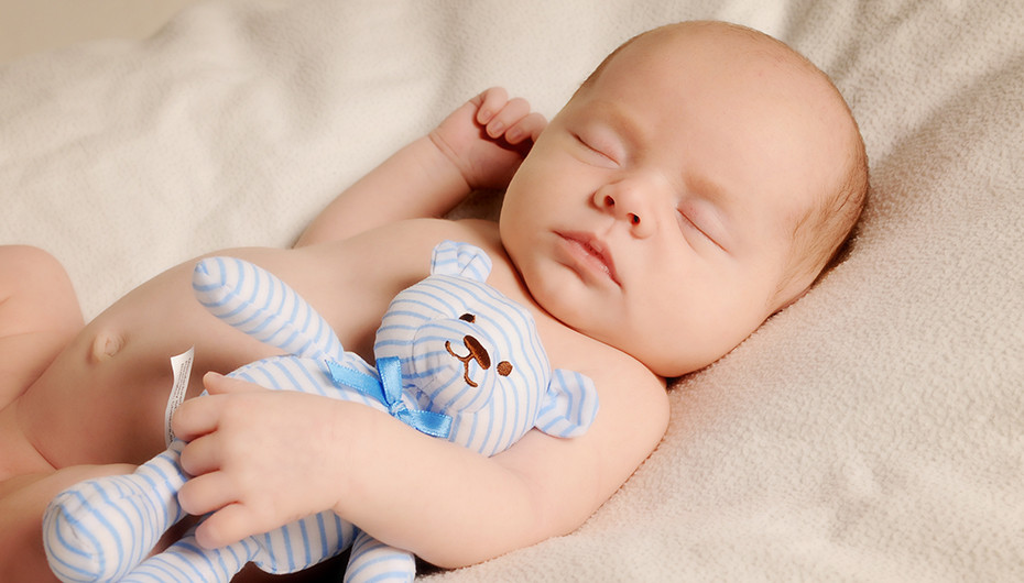 Beautiful image of sleeping baby with teddy bear. Photograph by Emotion Studios. 