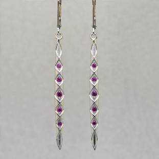 You will feel like a Princess wearing these striking, long dangling Pink Sapphire earrings. Set with very fine diamond cut Pink Sapphires weighing .30ct. T.W., set in 14 karat Brilliant White Gold dangling from lever backs. Earrings measure 2 1/4 inches long.

Designed, and created in our studio by the artist Stuart J.