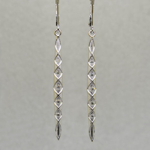 You will feel like a Princess wearing these striking, long dangling diamond earrings. Set with .20ct. T.W. of Ideal cut Diamonds, in 14 karat Brilliant White Gold, dangling from lever backs. Earrings measure 2 1/4 inches long.

Designed, and created in our studio by the artist Stuart J.