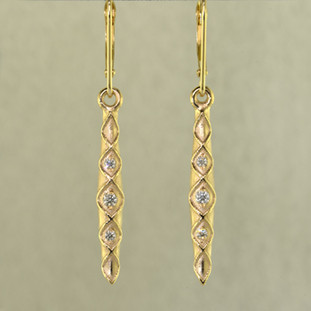 When you need just a touch of sparkle to jazz up your wardrobe, these 14 karat Yellow Gold diamond earrings are perfect. They are a perfect blend of traditional, and modern, to work with any outfit, and give you a confident feel, wether you are dressed up or dressed casual. Set with .12ct T.W. of Ideal cut Diamonds, with lever backs. Earrings measure 1 1/2 inches long.

Designed, and created in our studio by the artist Stuart J.