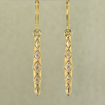 When you need just a touch of sparkle to jazz up your wardrobe, these 14 karat Yellow Gold diamond earrings are perfect. They are a perfect blend of traditional, and modern, to work with any outfit, and give you a confident feel, wether you are dressed up or dressed casual. Set with .12ct T.W. of Ideal cut Diamonds, with lever backs. Earrings measure 1 1/2 inches long.

Designed, and created in our studio by the artist Stuart J.