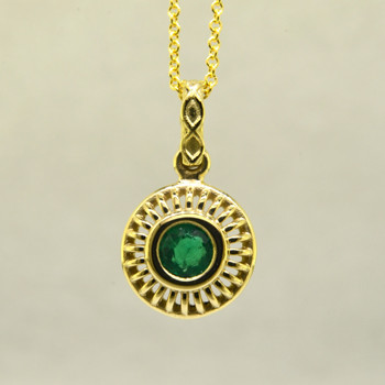 Blending traditional and modern for a timeless look, this diamond pendant dazzles day and night. Made in 18 karat Yellow Gold, with a vibrant .48ct. Emerald. This beautiful emerald pendant comes with an 18 karat Yellow Gold 1.3mm cable chain, 18 inches long. Pendant measures 3/4 inch long.  
Designed, and created in our studio by the artist Stuart J.