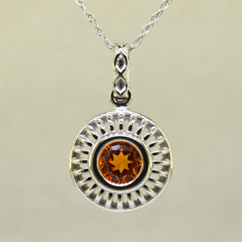 Blending traditional and modern for a timeless look, this diamond pendant dazzles day and night. Made in 14 karat White Gold, with a vibrant 1.17ct. Mandarin Garnet, custom cut for us by the famed stone cutters in Idar-Oberstein, Germany. This beautiful garnet pendant comes with a 14 karat White Gold, .07mm diamond cut wheat chain, 18 inches long. Pendant measures 3/4 inches long.  

Designed, and created in our studio by the artist Stuart J.