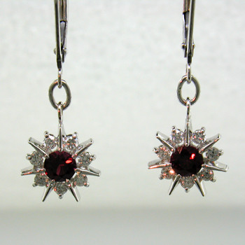 You will be the star with these sparkling 14 karat White Gold Ruby and diamond earrings. Set with two brilliant deep red Rubies, and .28ct. T.W. of Ideal cut Diamonds, dangling on lever backs. These earrings look like snowflakes, but sparkle like stars, so we call them Starflakes(tm), and they measure 1 inch long.  

Designed, and created in our studio by the artist Stuart J.