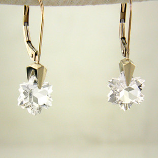 What's better than one sparkling snowflake? Two, of course. One for each ear. And you can turn up the heat, because these snowflakes won't melt. Exclusively ours, each colorless topaz snowflake is custom cut just for us, in Canada, by master gem cutters. Each snowflake measures 8mm, and dangles in a 14 karat white gold Piercette® setting on a lever back, measuring 1 inch long.

Designed, and created in our studio by the artist Stuart J.

A Piercette® is a patented method of setting, with a gemstone that moves. The gem is set so that it swivels with every movement of the wearer, exhibiting extra sparkle.

