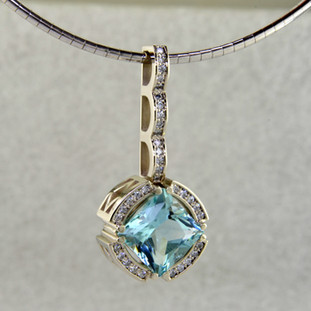 For an important occasion, you need an important, custom made, killer pendant. Like this one! Look closely and you will see the amazing detail, intricately carved into this 14 karat white gold pendant. The center piece of this masterpiece is a magnificant 4.58ct. princess cut Mint colored Beryl, custom cut for us by the famed stone cutters in Idar-Oberstein, Germany. Beryls come in many colors, the most familiar of which is green, which is Emerald. However the other colors are just as enticing, and much more unique. This fabulous gemstone is accented with .35ct. T.W. of Ideal cut Diamonds. Includes a 14 karat White Gold, 2mm round omega wire, 16 inches long.
Designed, and created in our studio by the artist Stuart J.