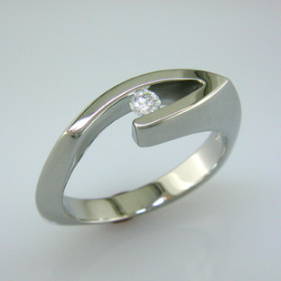 A classic, modern diamond ring perfect for everyday. Crafted in 14 karat White Gold with a .10ct. Ideal cut Diamond. Finger size 6 1/2, or allow us a week or so, and we will make it just for you.

Designed, and created in our studio by the artist Stuart J.
