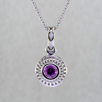 Blending traditional and modern, this pendant dazzles, day or night. Handcrafted in 14 karat White Gold, with a vibrant .40ct. round Pink Sapphire. This beautiful pendant comes with a 14 karat White Gold cable chain, 18 inches long. Pendant measures 5/8 inch long.

Designed, and created in our studio by the artist Stuart J.