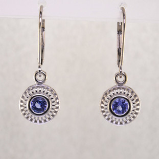 Blending traditional and modern design, these earrings dazzle, day or night. Handcrafted in 14 karat White Gold with sparkling 4mm Tanzanite gemstones, dangling on lever backs. Earrings measure 1 inch long.  

Designed, and created in our studio by the artist Stuart J.