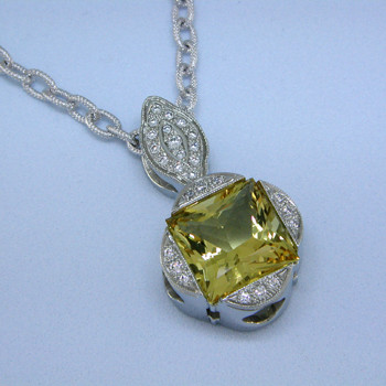 Eye-catching modern pendant with a traditional twist. Sculpted in 14 karat White Gold with a spectacular, one-of-a-kind 5.42ct. princess cut Yellow Beryl, custom cut for us by the famed stone cutters in Idar-Oberstein, Germany. Beryls come in many colors, the most familiar of which is green, which is Emerald. However the other colors are just as enticing, and much more unique. This fabulous gemstone is accented with .29ct. T.W. of Ideal cut Diamonds, and includes a 14 karat White Gold open link chain, 18 inches long. Pendant measures 1 1/8 inches long.

Designed, and created in our studio by the artist Stuart J.