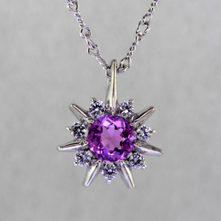 This beautiful pendant twinkles just like the stars at night. Our Starflake(tm) Sapphire and Diamond pendant is made in 14 karat White Gold, set with a mesmerizing 1.01ct. round Pink Sapphire, surrounded by .21ct. T.W. Ideal cut Diamonds. Includes a 14 karat White Gold twisted link chain, 18 inches long. Pendant measures 1/2 inch long.

Designed, and created in our studio by the artist Stuart J.