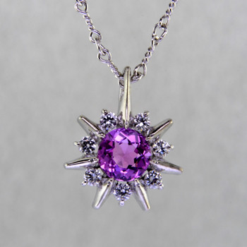 This beautiful pendant twinkles just like the stars at night. Our Starflake(tm) Sapphire and Diamond pendant is made in 14 karat White Gold, set with a mesmerizing 1.01ct. round Pink Sapphire, surrounded by .21ct. T.W. Ideal cut Diamonds. Includes a 14 karat White Gold twisted link chain, 18 inches long. Pendant measures 1/2 inch long.

Designed, and created in our studio by the artist Stuart J.