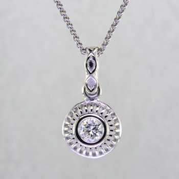 Blending traditional and modern for a timeless look, this diamond pendant dazzles day and night. Made in 14 karat White Gold, with a scintillating .24ct. Ideal cut Diamond. This beautiful diamond pendant hangs on a 14 karat White Gold 1.3mm cable chain, 18 inches long. Pendant measures 5/8 inch long.  

Designed, and created in our studio by the artist Stuart J.