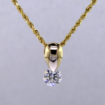 Simple and elegant, this Diamond Piercette® tear drop pendant sparkles from every angle. Specially set using a patented setting technique that allows the diamond to continuously move, and sparkle like crazy. This diamond pendant is made in 14 karat Yellow Gold with a .43ct. Diamond (G color, SI1 clarity), and includes a 14 karat Yellow Gold 1.1mm Diamond-cut rope chain. Pendant measures 3/8 inch long.
Designed, and created in our studio by the artist Stuart J.

A Piercette® is a patented method of setting, with a gemstone that moves. The gem is set so that it swivels with every movement of the wearer, exhibiting extra sparkle. 