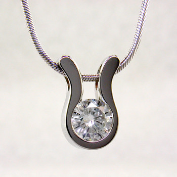 An elegant, modern shape makes this pendant a go-to for every occasion. 14 karat White Gold with a .22ct. (G SI2 Quality) Ideal cut Diamond, this pendant has a classic, timeless style. Includes a 14 karat White Gold 1mm cable chain, 18 inches long. Pendant measures 1/4 inch long.  

Designed, and created in our studio by the artist Stuart J.