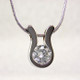 An elegant, modern shape makes this pendant a go-to for every occasion. 14 karat White Gold with a .22ct. (G SI2 Quality) Ideal cut Diamond, this pendant has a classic, timeless style. Includes a 14 karat White Gold 1mm cable chain, 18 inches long. Pendant measures 1/4 inch long.  

Designed, and created in our studio by the artist Stuart J.