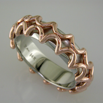 For the modern man, this ring is out of this world. 14 karat White Gold band with Rose Gold lattice pattern. Inside rounded band makes for added comfort.

This ring is a 10 1/2 and 7mm wide. This ring is custom made in your finger size, and takes about 2 weeks to create.

This is a special order item. Please call us to customize this ring just for you.

Designed, and created in our studio by the artist Stuart J.