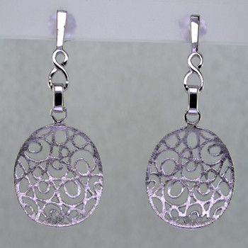 With an open lattice design, these light and airy earrings exude fun day or night. Easy to wear, and distinctively styled, they are handcrafted in durable rhodium plated Sterling Silver, dangling from posts. Measuring 1 1/2 inches long.

Handcrafted in Northern Spain.