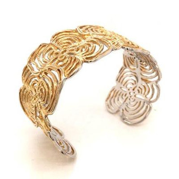 This delicate yet sturdy cuff bracelet showcases a striking flower motif, and is crafted in rich yellow gold plated Sterling Silver. Great style for any occasion. Bracelet measures 1 1/4 inches wide.

Handcrafted in Northern Spain.