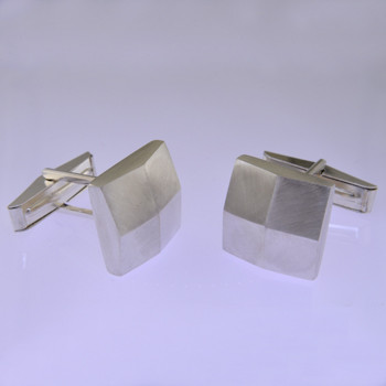 These solid Sterling Silver cufflinks look modern and sophisticated. Hand finished with a classic square shape, and light textured finish for an understated, but distinctive look. Measures 5/8 inch.

by David Heston of San Rafael, California.