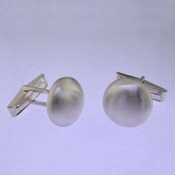 These solid Sterling Silver cufflinks look modern and sophisticated. Hand finished with a classic round shape, and light textured finish for an understated, but distinctive look. Measures 5/8 inch.

by David Heston of San Rafael, California.