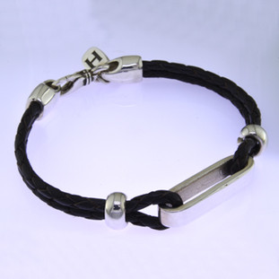 For the man who is edgy and modern, this bracelet will make a statement. Hand-crafted in brown Leather surrounded by a Sterling Silver shiny loop and shiny Silver handmade accents on the sides of the bracelet. Measures 8" long.

Made in northern California.