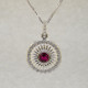 Mixing traditional with modern, this white gold pink tourmaline pendant is sophisticated and classy. Wear it any time, day or night. Crafted in 14 karat White Gold, set with a rich red .50ct. round pink Tourmaline gemstone, and surrounded by .22ct. T.W. of Ideal cut Diamonds. A delicate Diamond bail tops off this beautiful pendant. Includes a .07mm 14 karat White Gold Diamond cut wheat chain, 18 inches long. Measures 1 inch.

Designed, and created in our studio by the artist Stuart J.