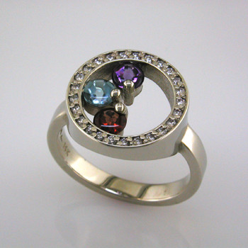 A Mother's ring for now. Elegant, and classy, you will be proud to wear this family birthstone every day. This diamond and birthstone Mother's ring is priced in 14k gold, and can be made in any karat or color of gold, and in platinum. It is individually crafted to be Perfectly You, and takes about 2 weeks to create.

Call us for more information about how we can customize this design Just For You. 

Designed, and created in our studio by the artist Stuart J.